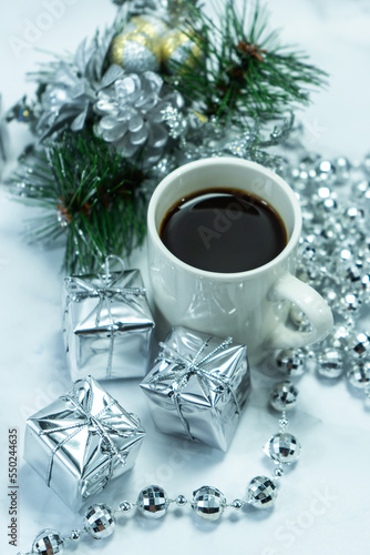 Christmas decorations on the table with a cup of coffee. Christmas background with coffee. Merry Christmas greeting card, frame, banner. Space for text. Selective focus. Selective focus
