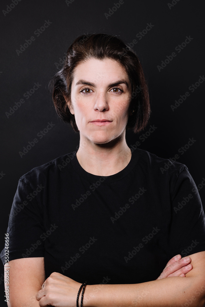 serious woman looking at camera on black background serious woman looking at camera on black background
