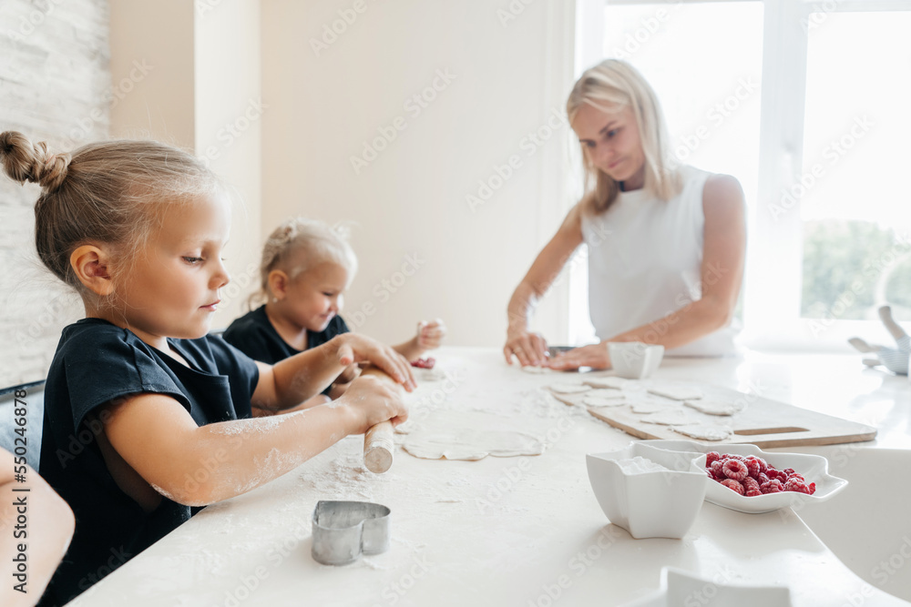 Children making cookies in the kitchen at home. Children making cookies in the kitchen at home.