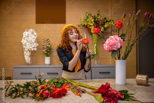 Ginger long-haired girl with flowers looking romantic photo