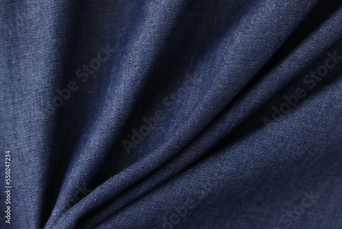 Shaped grey-blue textile as background.