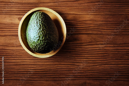 Avocado on a wooden table.Close-up. Fruit healthy food concept.