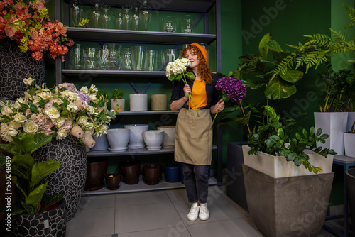 Cute smiling girl with flowers looking enjoyed photo