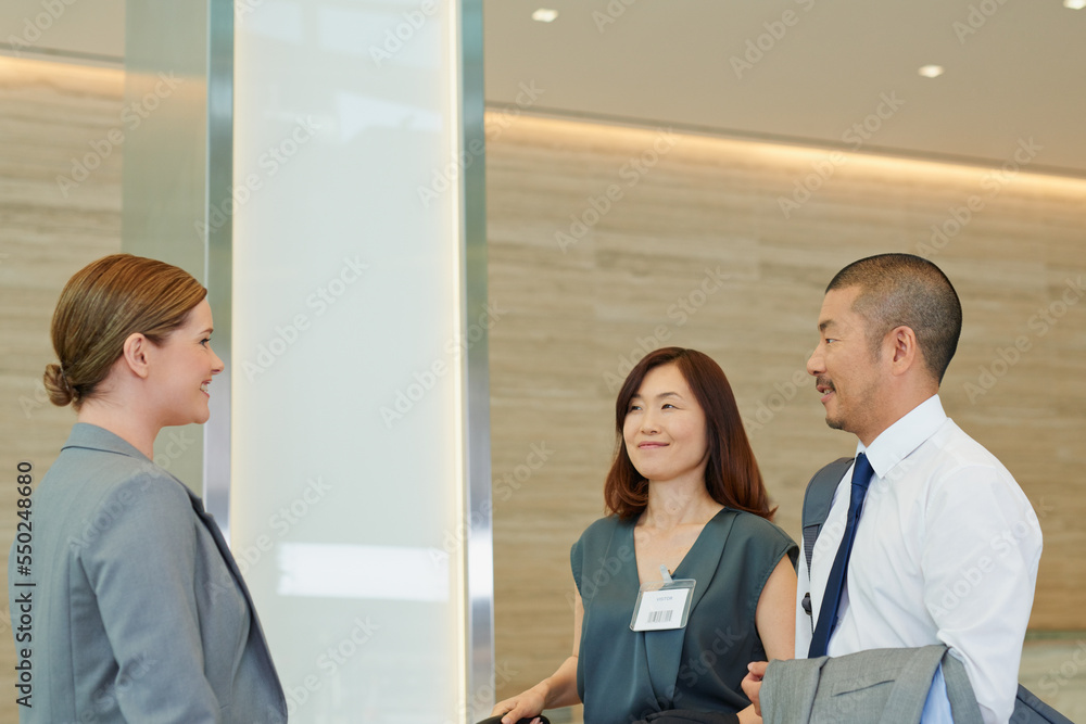 Business people, hotel concierge and check in at luxury hospitality, corporate travel and asian people. Company employee at receptionist for work convention, travelling and staff book for conference Business people, hotel concierge and check in at luxury hospitality, corporate travel and asian people. Company employee at receptionist for work convention, travelling and staff book for conference