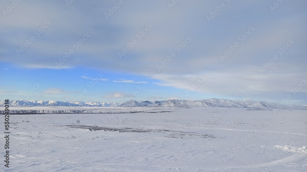 Winter arctic landscape with mountains in the background Winter arctic landscape with mountains in the background