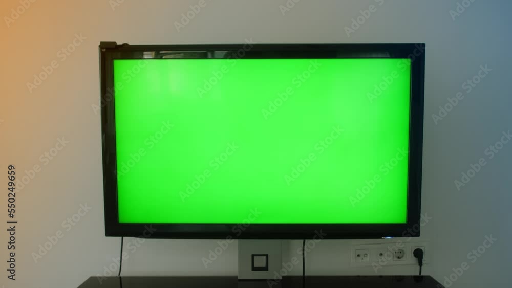 TV Green Screen in living room. Chroma key screen for advertising. TV Green Screen in living room. Chroma key screen for advertising.