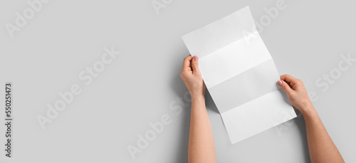 Hands with blank brochure o...