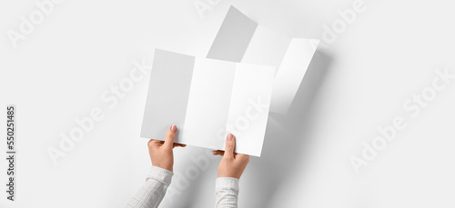 Hands with blank brochures ...