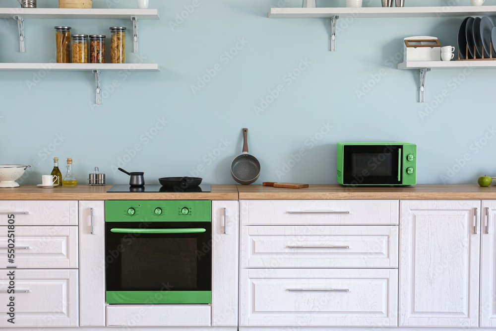 Interior of kitchen with modern green household appliances Interior of kitchen with modern green household appliances
