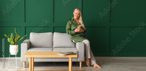 Mature woman drinking tea w...