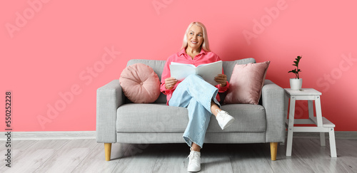 Mature woman reading book w...