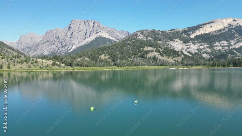 Aerial Drone View Of Tourists Kayaking On Serene Green River Lakes In Wyoming. Aerial Drone View Of Tourists Kayaking On Serene Green River Lakes In Wyoming.