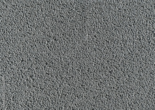 Fondo con detalle y textura de superficie de asfalto rugoso en tonos grises
