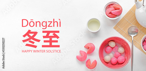 Greeting card for Chinese Dongzhi festival (Winetr Solstice) with tasty tangyuan on white background photo