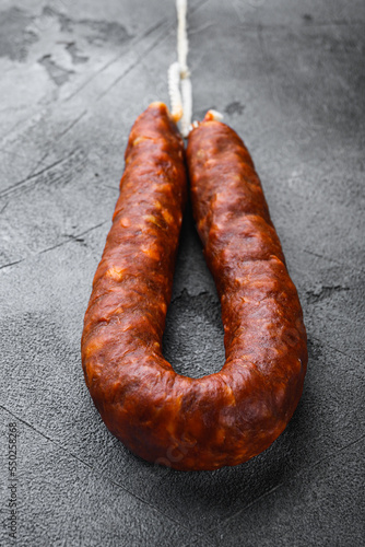 Traditional sausage chorizo salami on grey textured background