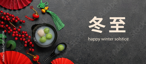 Greeting card for Chinese Dongzhi festival (Winetr Solstice) with tasty tangyuan on dark background photo