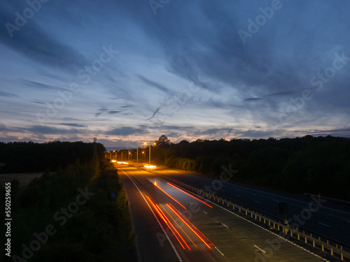 Fototapeta Naklejka Na Ścianę i Meble -  Light trails on the M20 motorway at dusk, Kent, UK