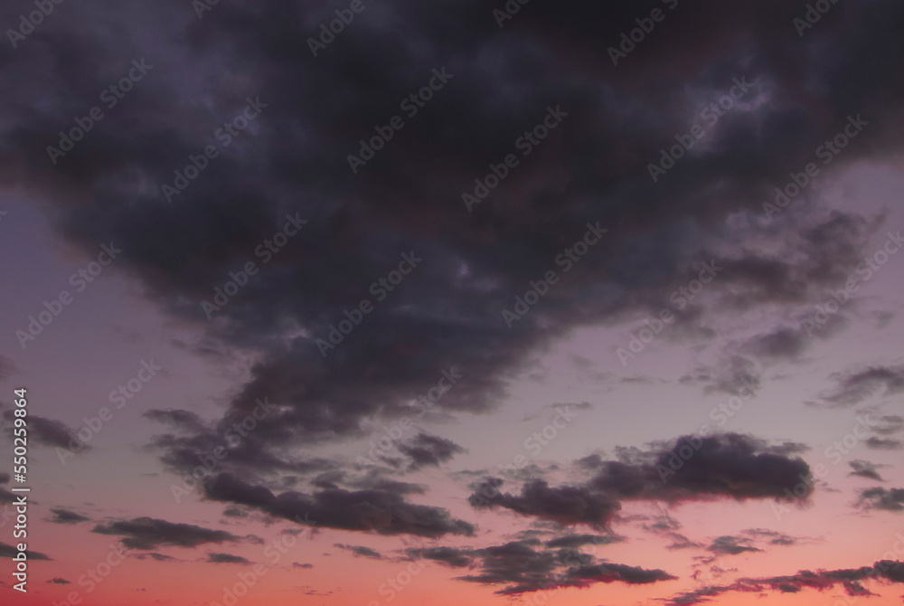 Pink purple clouds in the sky at dusk Pink purple clouds in the sky at dusk