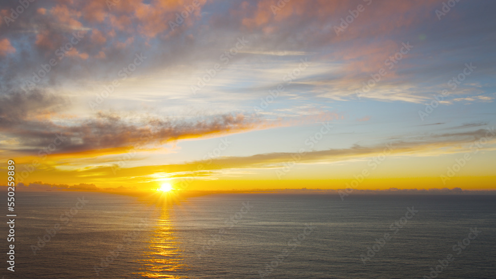 Breathtaking sunset in the calm ocean at the Cabo da Roca, Portugal.