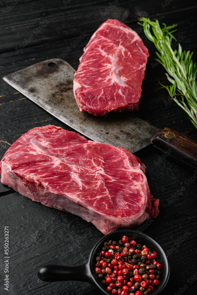 Fresh beef meat Top Blade steaks, on black wooden table background