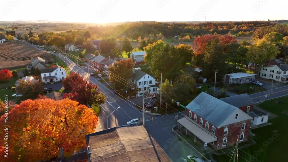 Small town in USA during autumn. Village in United States during autumn golden hour sunset. Aerial view of intersection. Small town in USA during autumn. Village in United States during autumn golden hour sunset. Aerial view of intersection.