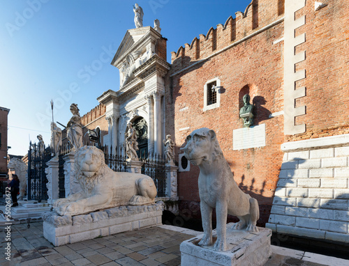 Venezia. Facciata con i leoni dell'Arsenale al tramonto photo