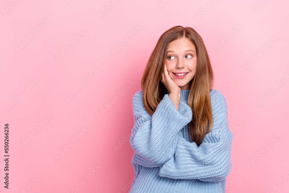 Photo of nice young brown hair teen schoolgirl wear blue knitted pullover touch cheeks looking shy empty space isolated on pink color background Photo of nice young brown hair teen schoolgirl wear blue knitted pullover touch cheeks looking shy empty space isolated on pink color background