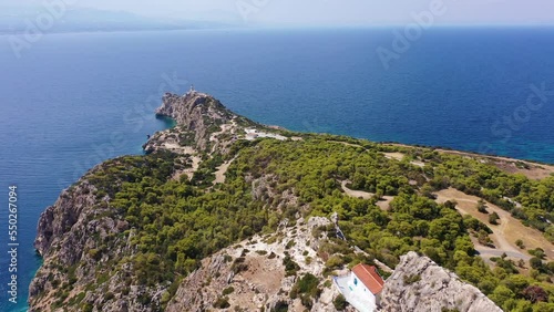 Aerial drone video of famous archaeological site of Heraion in Cape Melagavi featuring a small beach next to iconic lake Vouliagmeni and lighthouse, Corinthian bay, Perachora, Loutraki, Greece photo