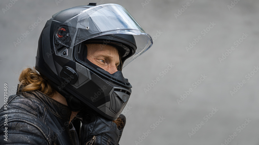 Motorcycle rider wears safety helmet, free space to insert Motorcycle rider wears safety helmet, free space to insert