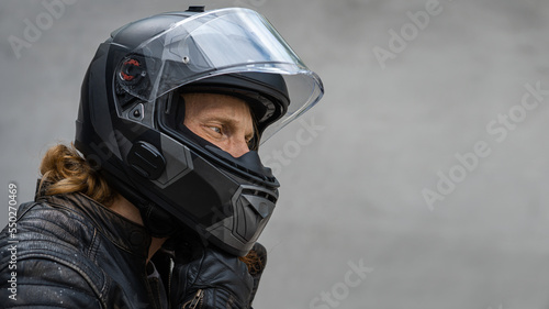 Motorcycle rider wears safety helmet, free space to insert © uladzislaulineu