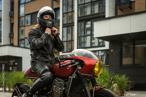 Wallpaper Mural Biker wears safety helmet sitting on motorcycle