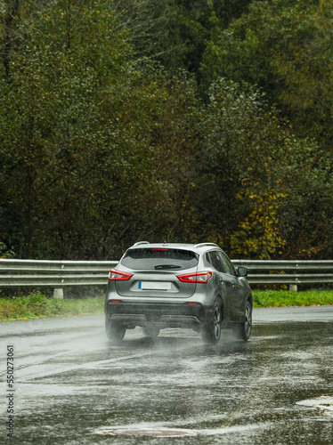 road in rainy winter with car