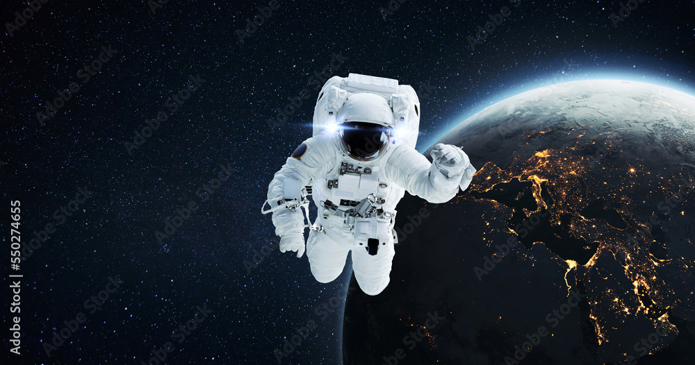 Space man astronaut flying in outer space with amazing night planet earth  with city lights. Successful start of space mission and space exploration  Stock Photo