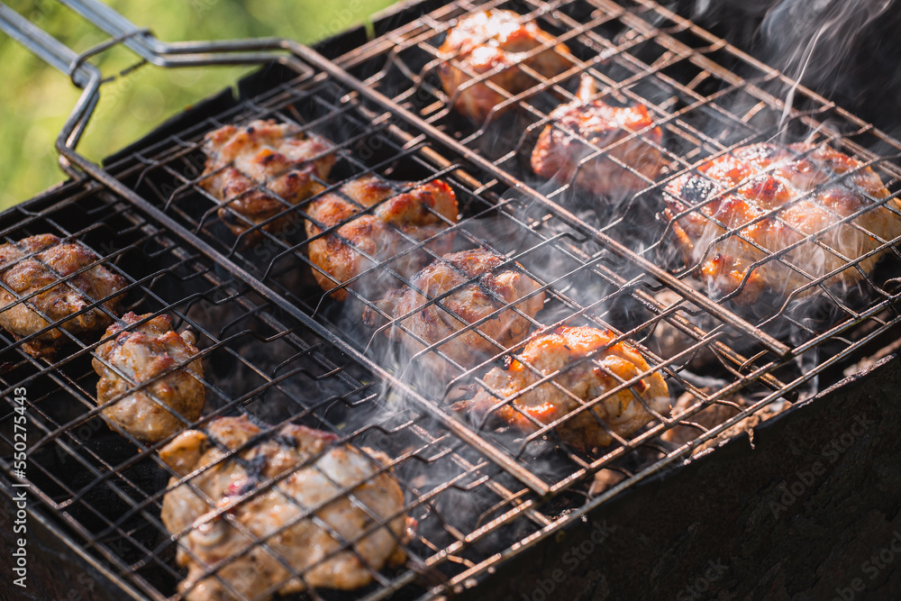 Fried browned crust on barbecue chicken - smoke and sparks from hot coals