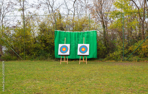Two archery targets set on a sports field