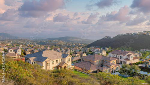 Panorama Puffy clouds at sunset Suburban residences on a mountain from the view at Double Peak P © Jason