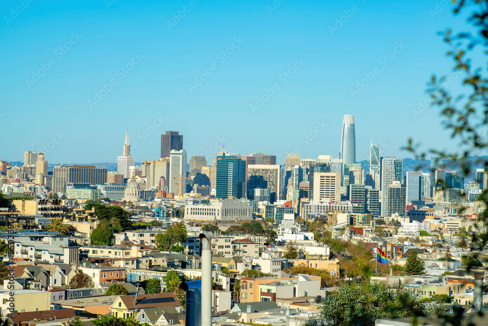 View from overlook towards the downtown city in the historic districts of San Francisco California in mid afternoon sun with trees