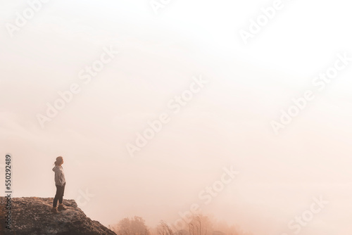 A Tourist enjoying with fog in Chiangmai, Thailand. A girl on the mountain with beautiful fog. The Beautiful Morning Time. Travel and tourism. Young woman on the peak of the mountain with morning fog 
