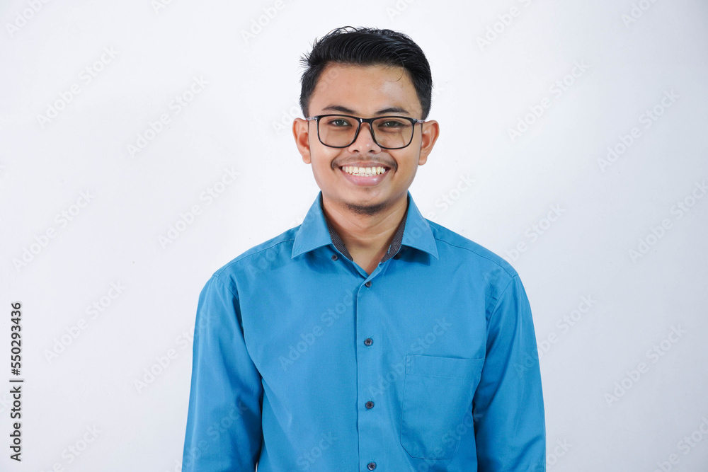 portrait smiling or happy asian young businessman with glasses standing and looking camera wearing blue shirt isolated on white background portrait smiling or happy asian young businessman with glasses standing and looking camera wearing blue shirt isolated on white background