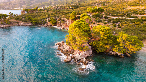 Beautiful azure blue Mediterranean beach surrounded by green trees in Croatia