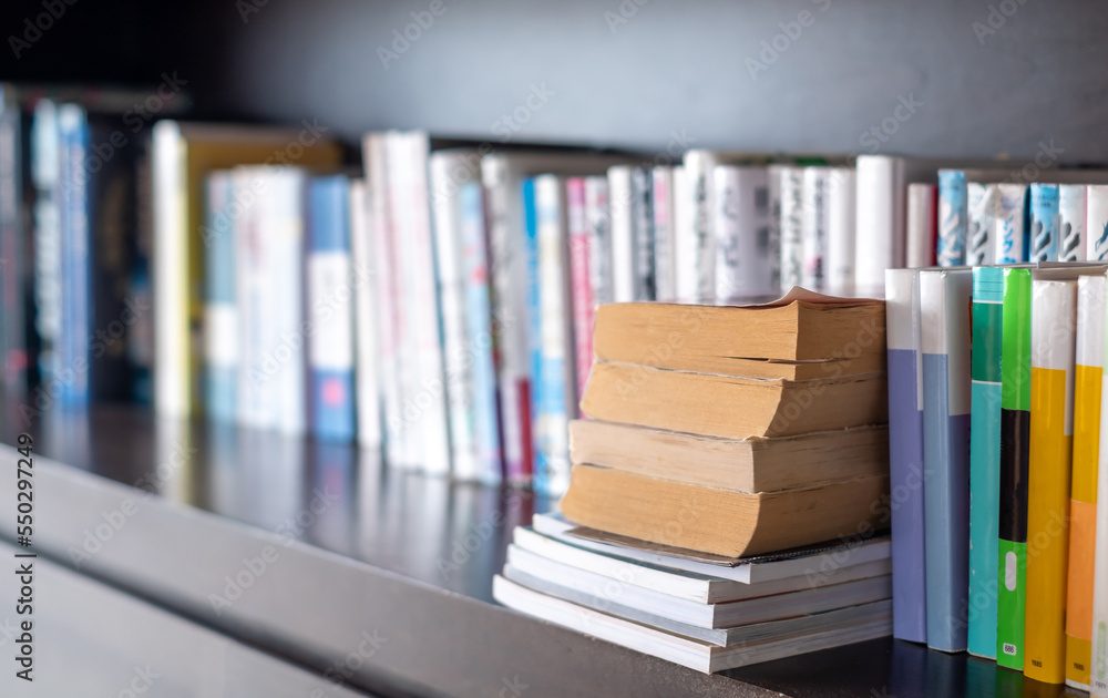 piles of old books lying on bookshelves