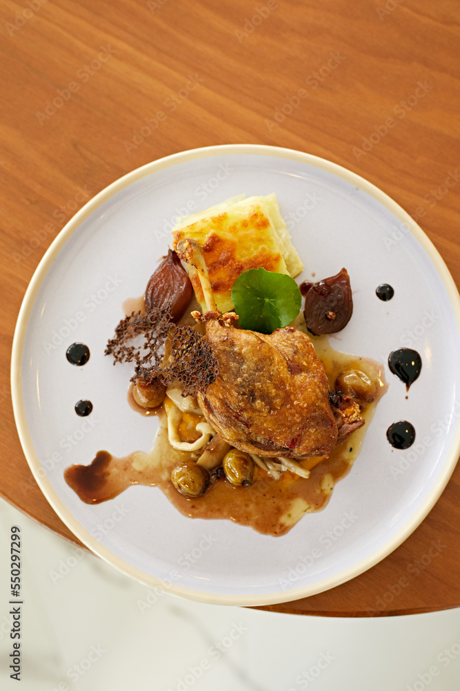 Roasted duck leg in prune sauce