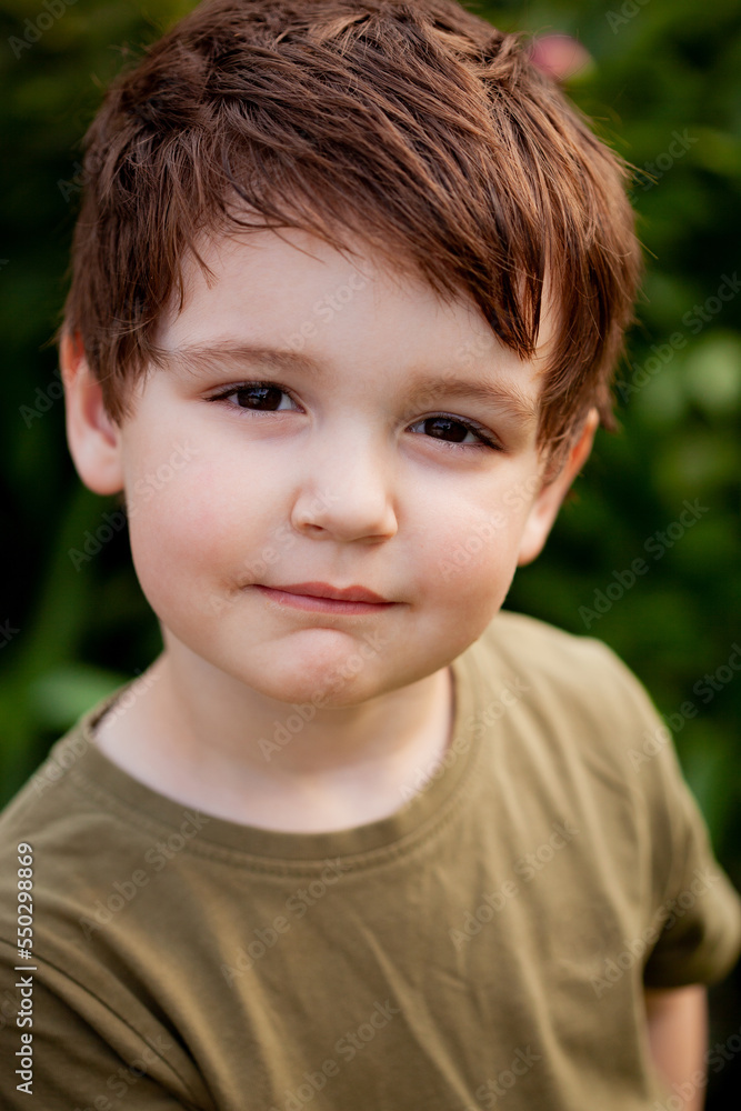 portrait of a boy outside in natural light, the boy staring straight into the camera portrait of a boy outside in natural light, the boy staring straight into the camera