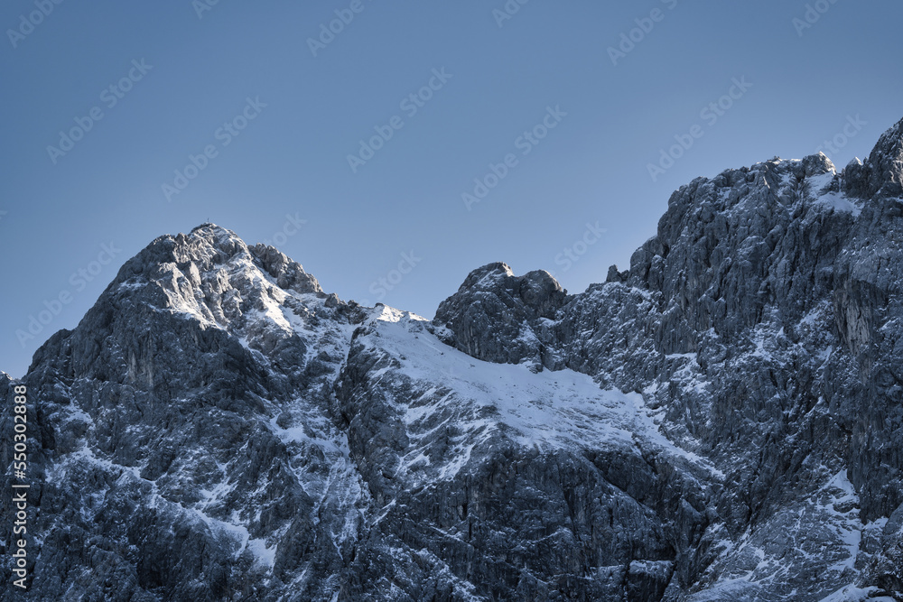 snow covered mountains with blue sky, clouds a little bit sun - Zugspitze, Alps