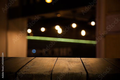 dark blurred background with empty table top  cafe restaurant windows. background for your product