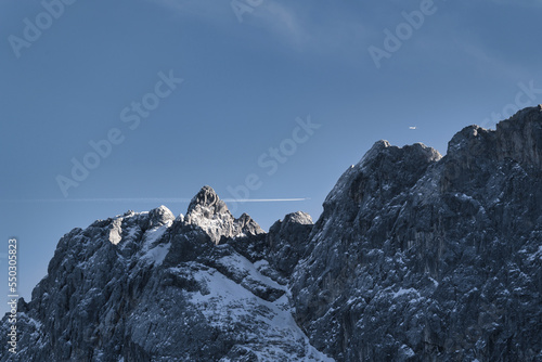 Two planes at the same time over the Zugspitze, snow covered mountain in the alps