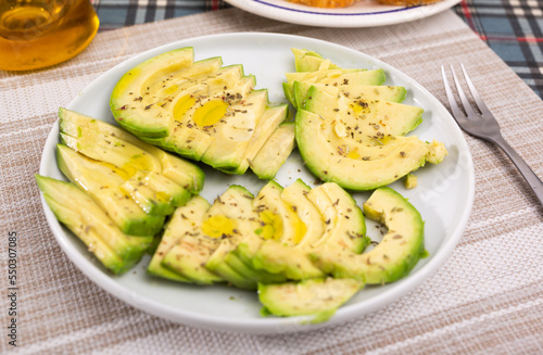 ripe avocado pulp cut into pieces sprinkled with lemon juice on a plate