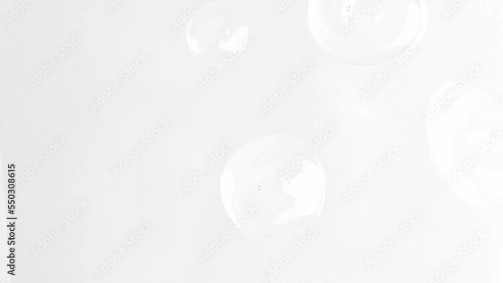 Transparent cosmetic drops of liquid skin care product body serum, hyaluronic acid top view. Transparent cosmetic drops of liquid skin care product body serum, hyaluronic acid top view.