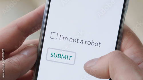 Obraz na płótnie I m not a robot checkbox on phone screen with Submit button. Concept, technology, human check, verification, hands, close up, ai. w salonie
