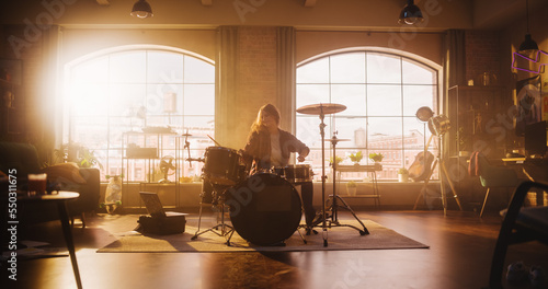 Slika na platnu Expressive Drummer Girl Playing Drums in a Loft Music Rehearsal Studio Filled with Light